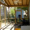 Screened porch with exposed rafters, plank look ceiling, and perimeter shelf